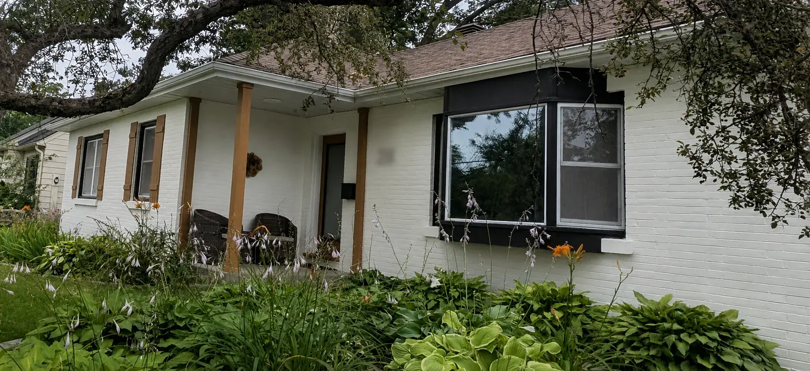 Finished exterior painting in Letitia Heights, Barrie, showing painted brick, window trim, posts, and shutters